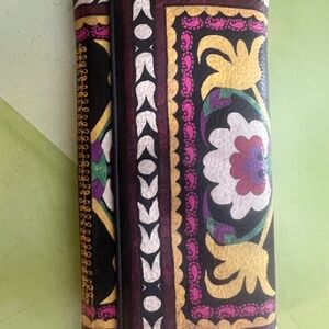 Etro wallet, French purse style.  Black background with multi colored design.